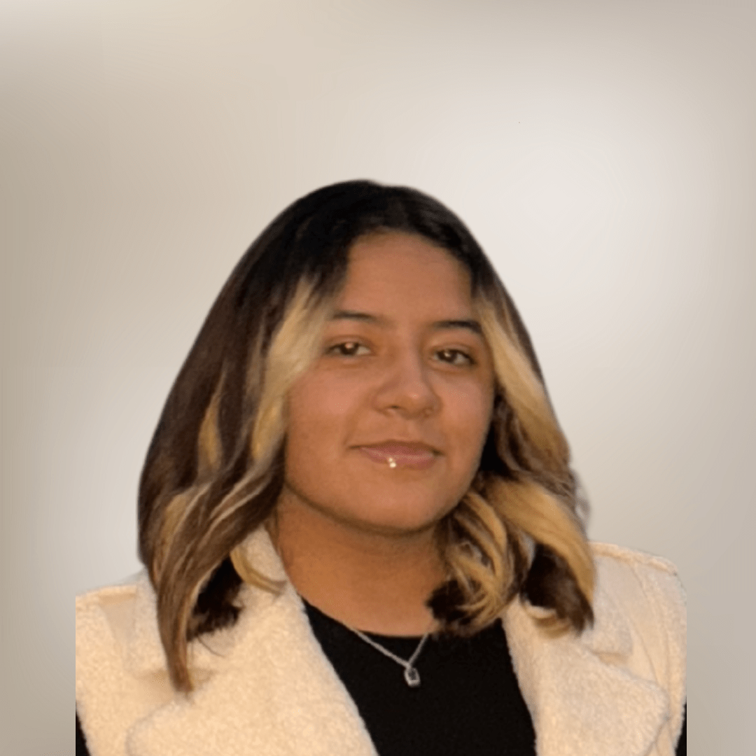 Person with highlighted hair and a gentle smile.